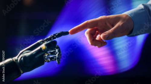 Humanoid Robot Arm Touches Human Hand Connecting Fingers. Humanity and Artificial Intelligence Unifying Gesture.Technology Merges with Creative Human Mind. Inspired by Michelangelo s Creation of Adam 