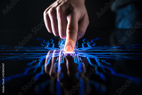 Digitalization Concept: Human Finger Pushes Touch Screen Button and Activates Futuristic Artificial Intelligence. Visualization of Machine Learning, AI, Computer Technology Merge with Humanity 