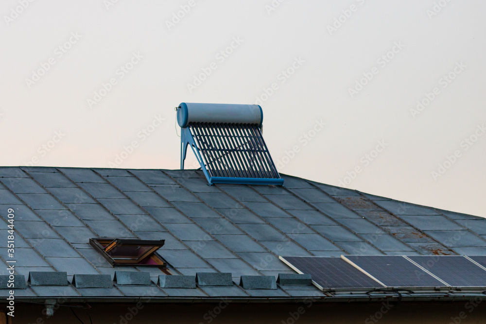 Solar water heater on roof top. Solar panel for hot water, system on roof. Stock Photo Adobe Stock