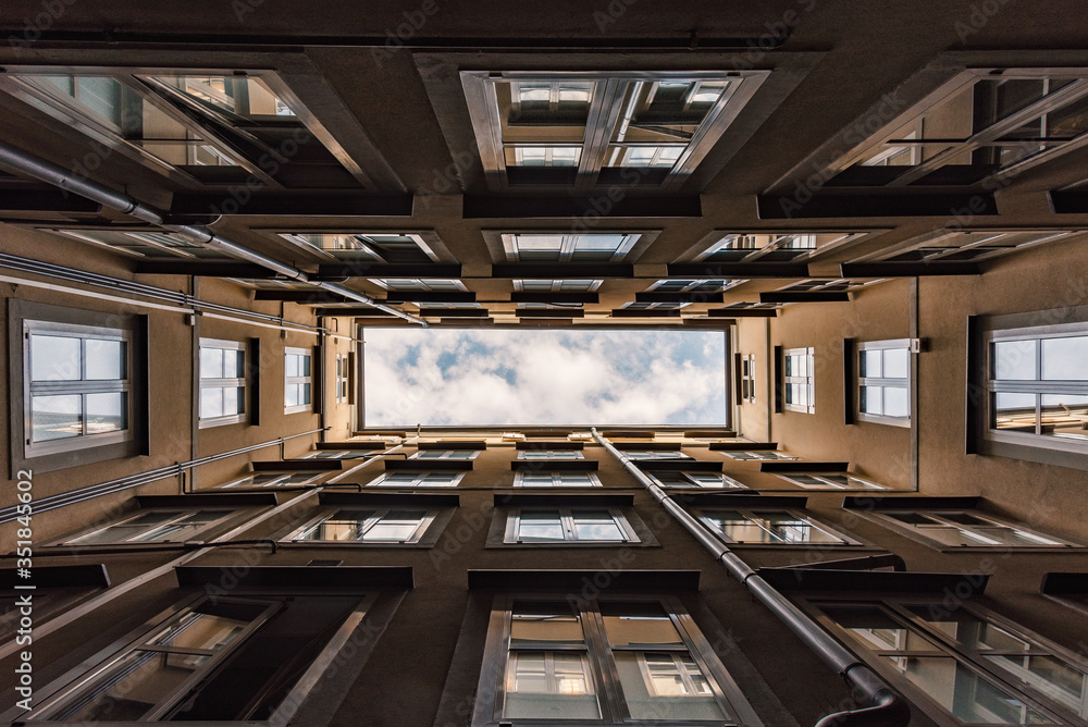 Sky view from the bottom of the courtyard of the building, forming a rectangle view