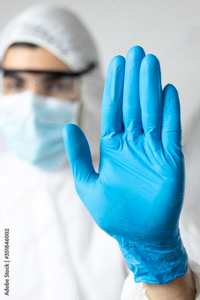 doctor with coronavirus protective clothing asking to stop the pandemic. stay at home