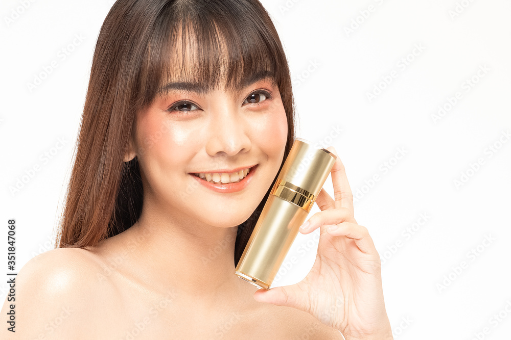 Beauty asian woman brown hair looking smile in camera happiness and hold bottle cosmetic cream lotion and cheerful with make up brush,Beauty Concept on white background. Beauty asian woman brown hair looking smile in camera happiness and hold bottle cosmetic cream lotion and cheerful with make up brush,Beauty Concept on white background.