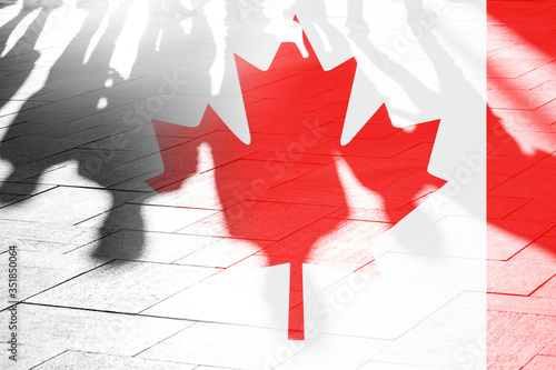 Shadows of people and Flag of Canada on surface, concept political picture