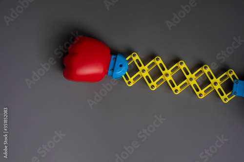 Toy boxing glove on a retractable arm