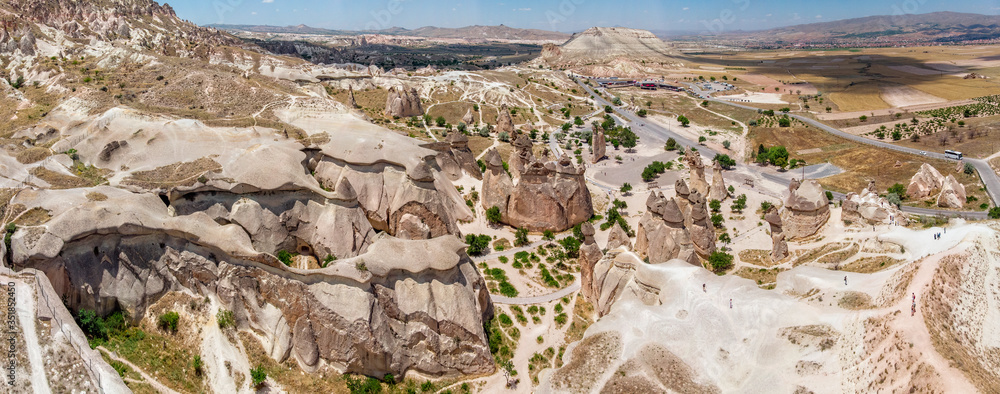Aerial view of Goreme National Park, Goreme Tarihi Milli Parki, Turkey. The typical rock formations of Cappadocia with fairy chimneys and desert landscape. Travel destinations, holidays and adventure