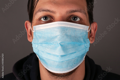 portrait of a caucasian man in a medical mask close up