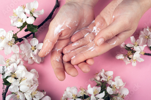 beauty and skin care hand with white flowers on a pink background