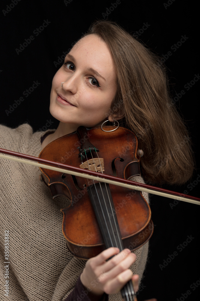 Attractive smiling woman violinist playing violin Attractive smiling woman violinist playing violin