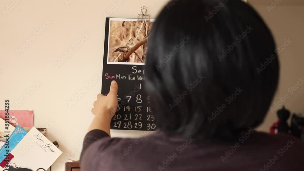 Woman put a calender on the wall. Original design. October. Woman put a calender on the wall. Original design. October.
