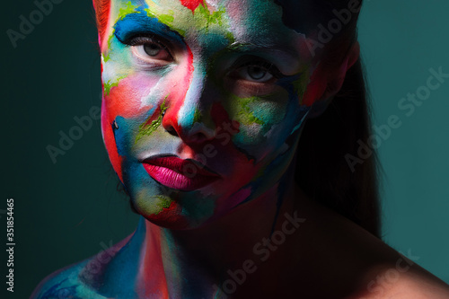 Multicolored skin, difficult to identify. Creative makeup and drawing on the face.