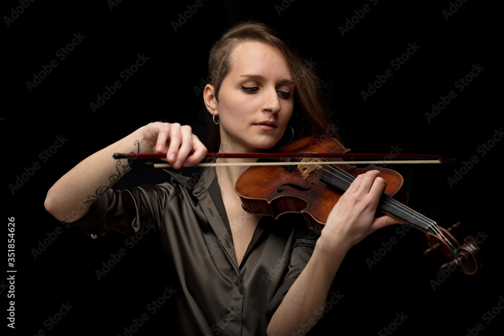 Passionate woman violinist playing classical music