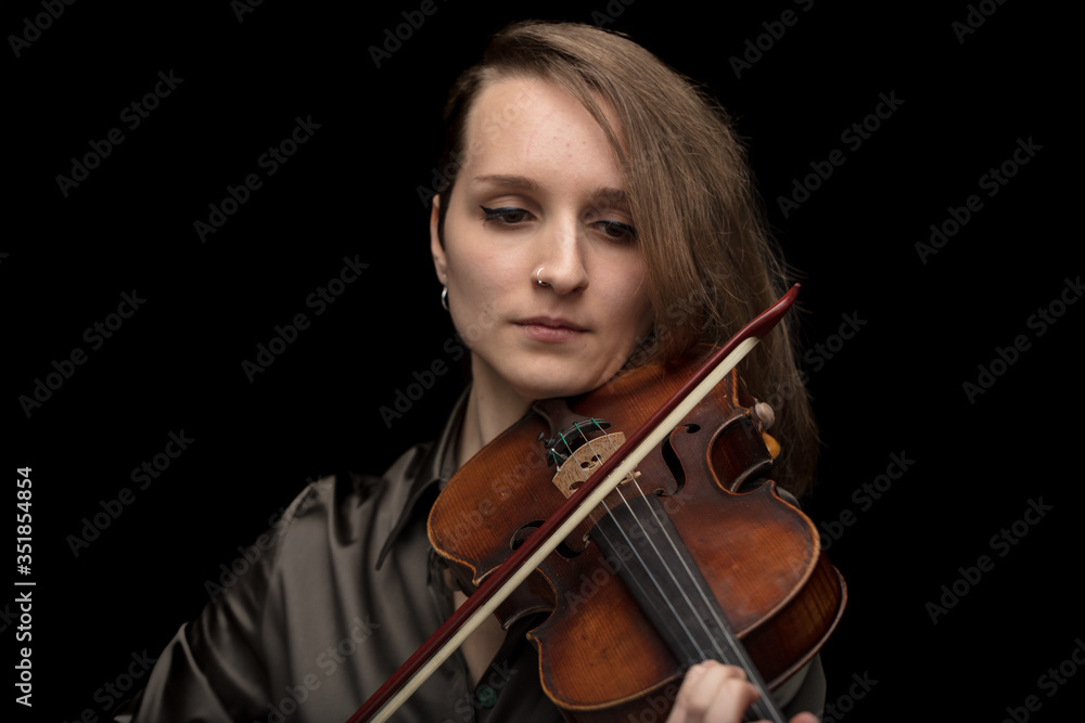 Dedicated woman playing a Baroque violin Dedicated woman playing a Baroque violin