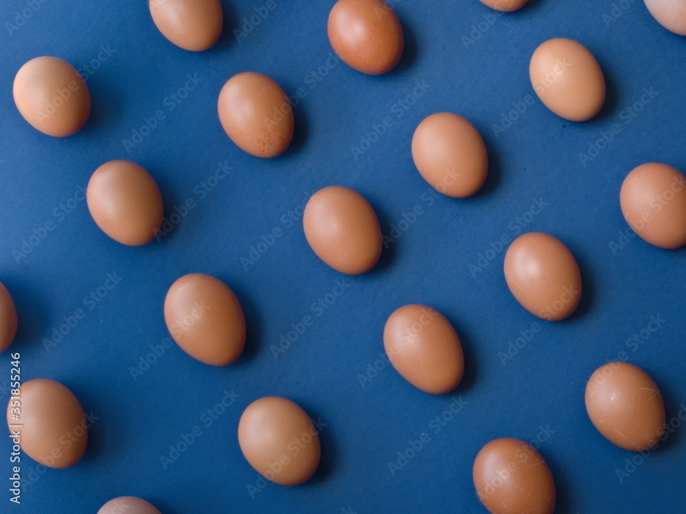 Eggs in line forming diagonals on blue background