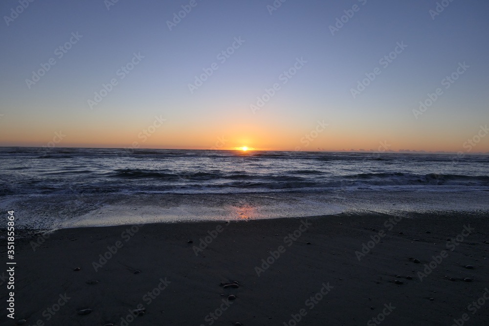 Far advanced sunset on a beach in New Zealand 