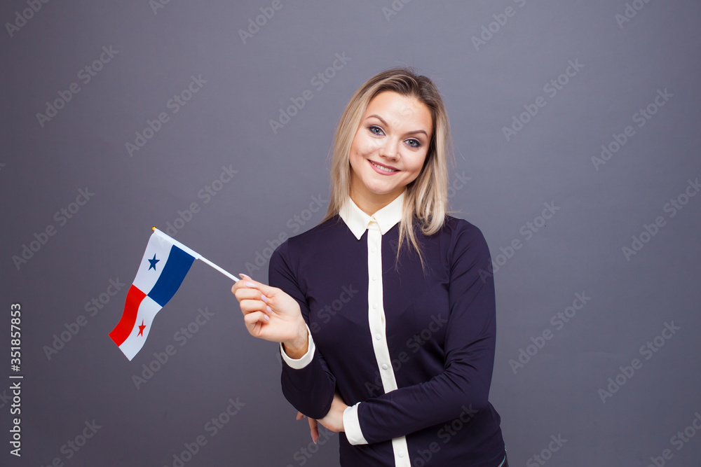 Immigration and the study of foreign languages, concept. A young smiling woman with a Panama flag in her hand Immigration and the study of foreign languages, concept. A young smiling woman with a Panama flag in her hand