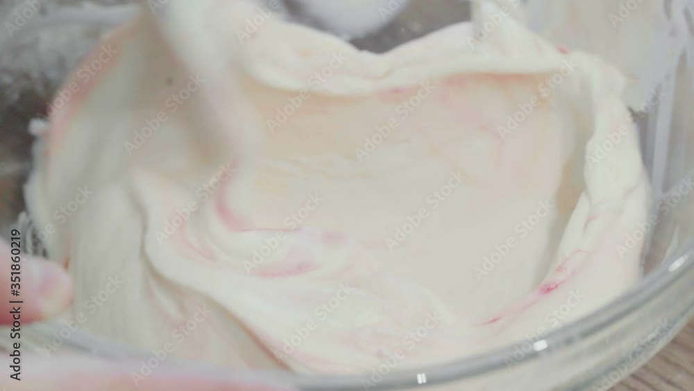 Mixing cream in bowl. Woman makes a cake at home Mixing cream in bowl. Woman makes a cake at home