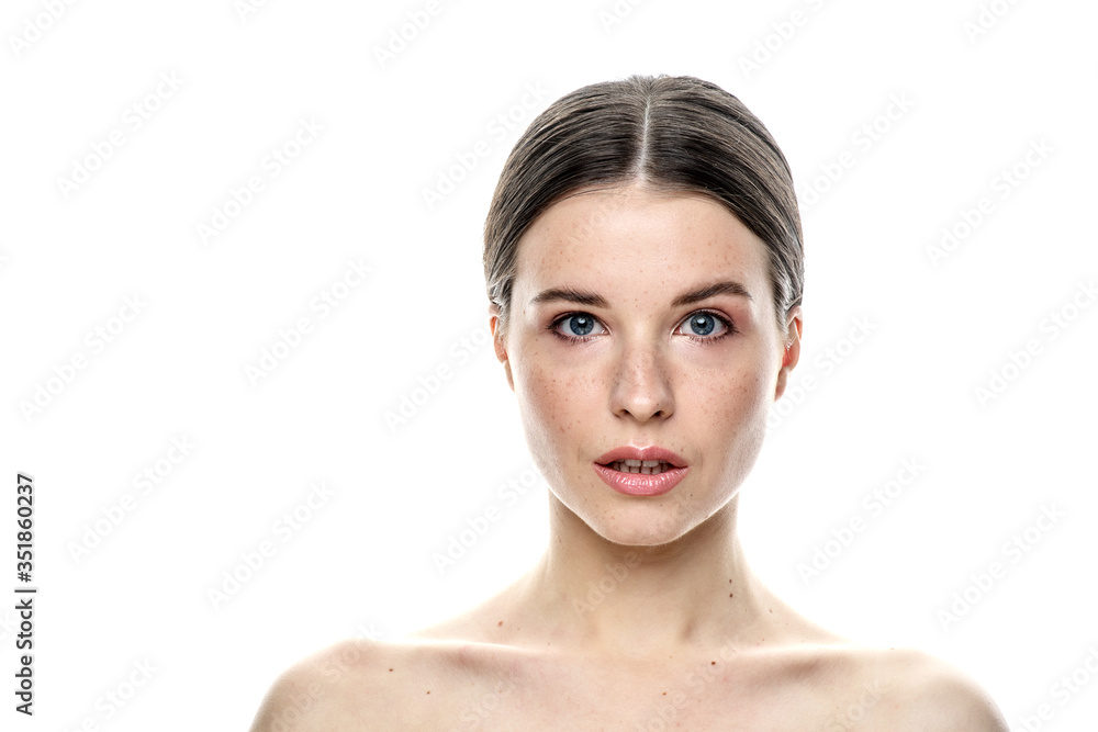 A close-up portrait of a girl with freckles and clear skin. Light blue eyes. The girl has different emotions, she looks at the camera. Isolated on a white background A close-up portrait of a girl with freckles and clear skin. Light blue eyes. The girl has different emotions, she looks at the camera. Isolated on a white background