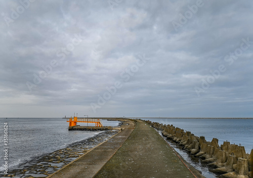 Concrete water pier in Swinoujscie with Baltic sea and breakwaters around