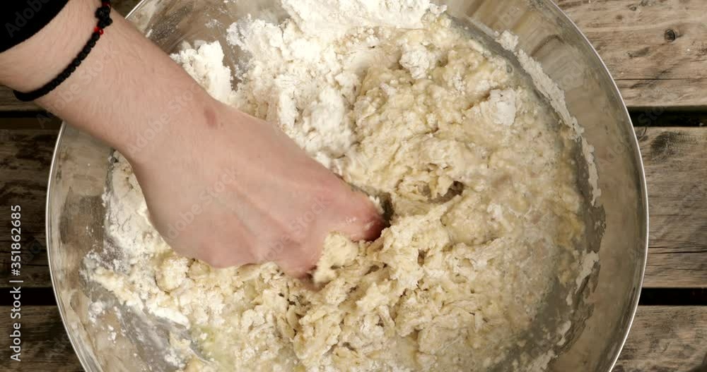 Hand mixing dough in a bowl Hand mixing dough in a bowl
