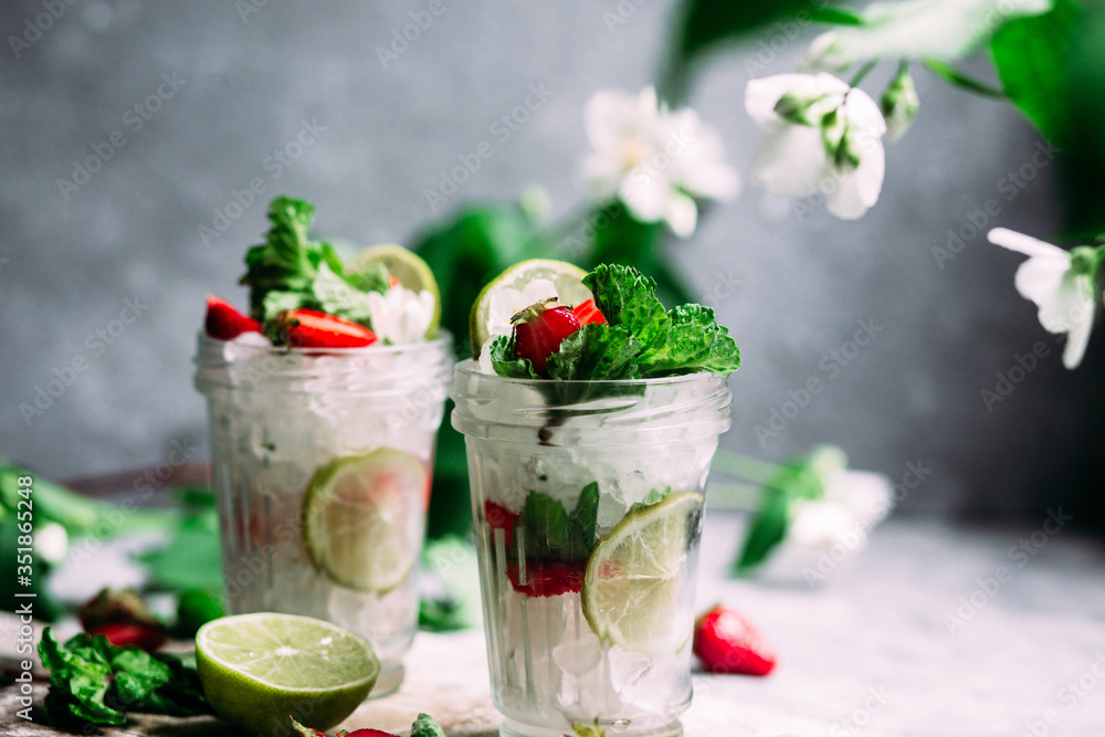 Mojito cocktail with strawberries, mint and lime. Lemonade Mojito cocktail with strawberries, mint and lime. Lemonade