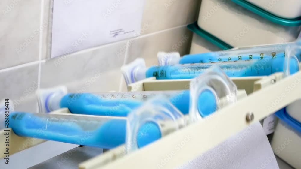In a scientific laboratory, a machine with blue ampoules is operating. the science 2020
