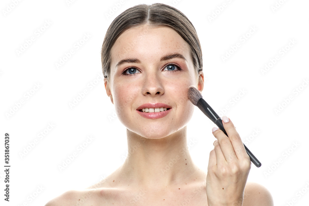 close-up portrait of a young brunette girl with blue eyes with clear skin, doing makeup with makeup brushes, isolated on a white background. High-resolution photos close-up portrait of a young brunette girl with blue eyes with clear skin, doing makeup with makeup brushes, isolated on a white background. High-resolution photos