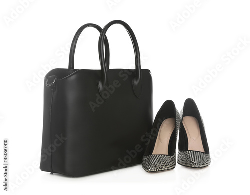Stylish woman's bag and shoes isolated on white