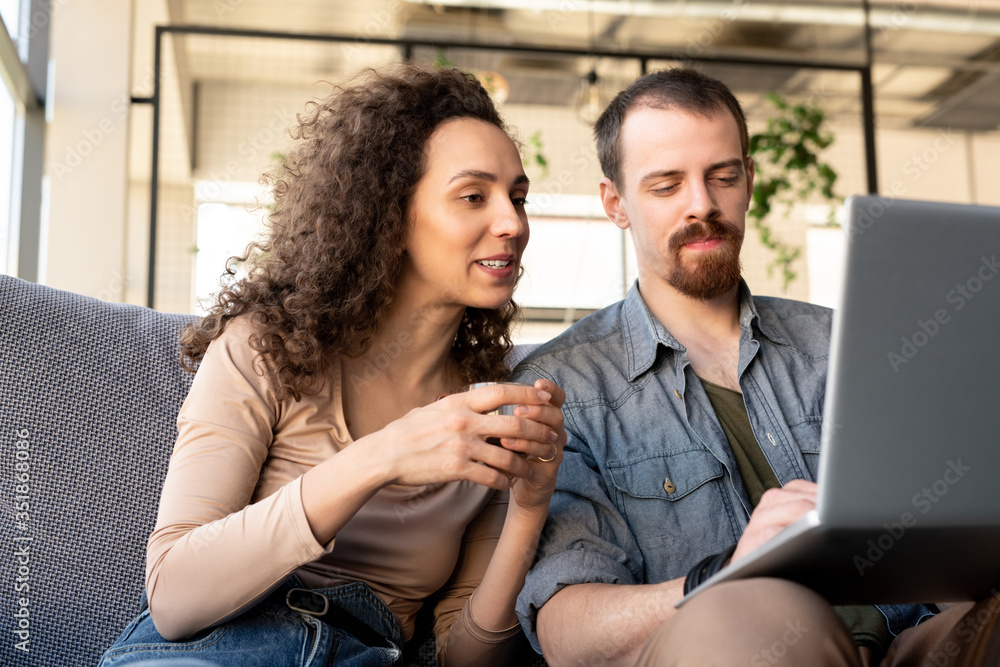 Young owners of luxurious restaurant or cozy cafe discussing online ideas Young owners of luxurious restaurant or cozy cafe discussing online ideas