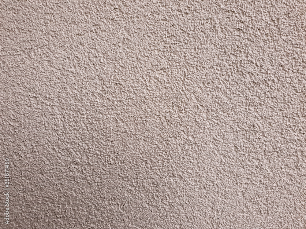 A close up view of white plastered wall with grainy finishing. Building exterior. Background texture. Horizontal view. A close up view of white plastered wall with grainy finishing. Building exterior. Background texture. Horizontal view.