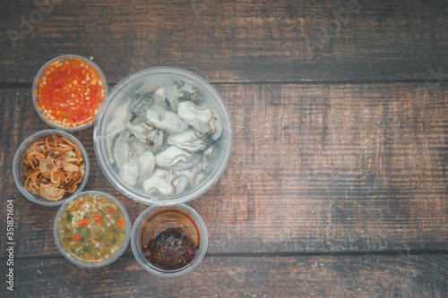 Raw oyster and side dishes in box in Thai style