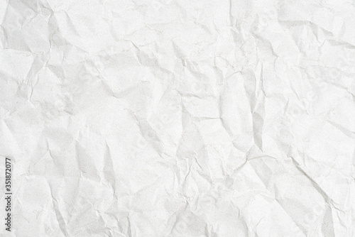 Texture of a crumpled sheet of white paper as a background