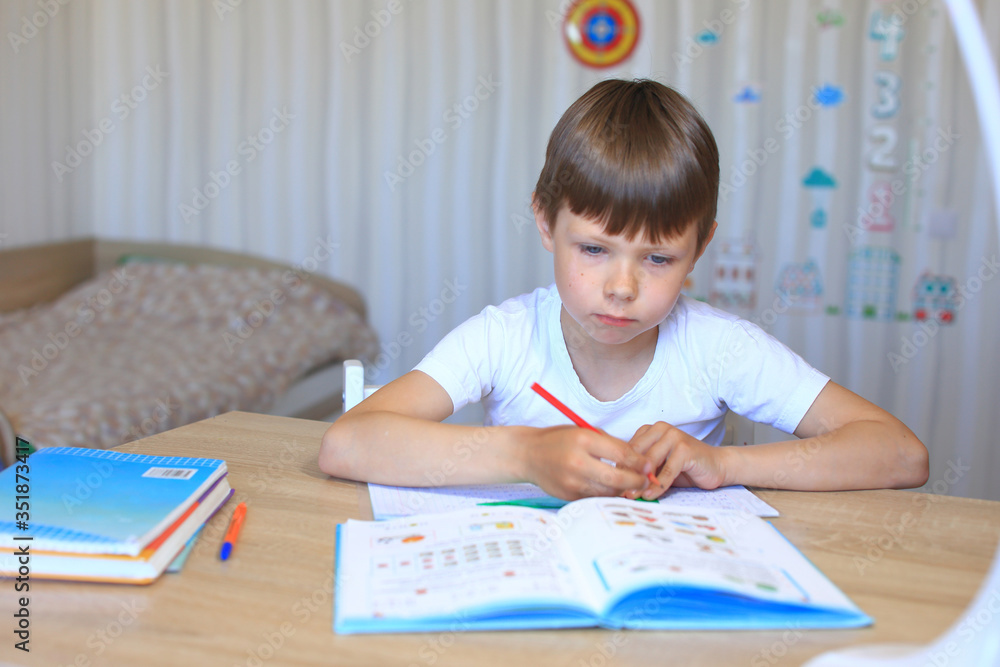 A child does homework on isolation. Homework. A child does homework on isolation. Homework.