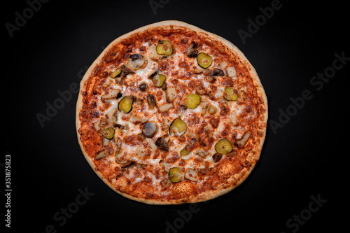 crispy Italian delicious pizza on a black background, pizza ingredients, photo for recipe and menu
