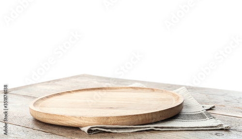 Empty plate and napkin on wooden table against white background
