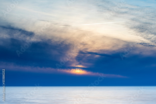 Vibrant cloudy summer sunset over ocean, Sweden © It4All