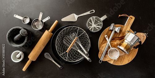 Kitchen utensils (cooking tools) on black chalkboard background
