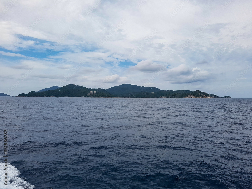island mountain hill ferry transport ocean sea tropical gulf thailand grey sky cloud koh phangha ko samui tao dive ship