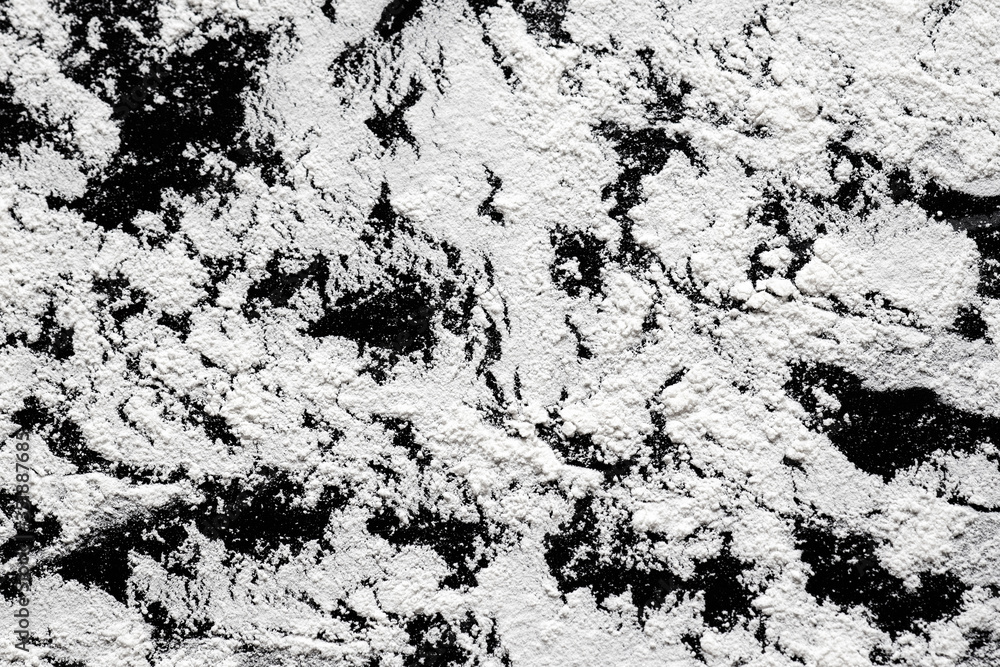 white wheat flour scattered on a black table, sifted flour texture, preparation for kneading dough, background for recipes and baking white wheat flour scattered on a black table, sifted flour texture, preparation for kneading dough, background for recipes and baking