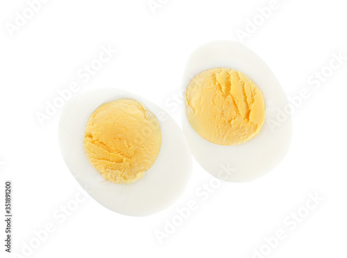 Halves of fresh hard boiled chicken egg isolated on white, top view