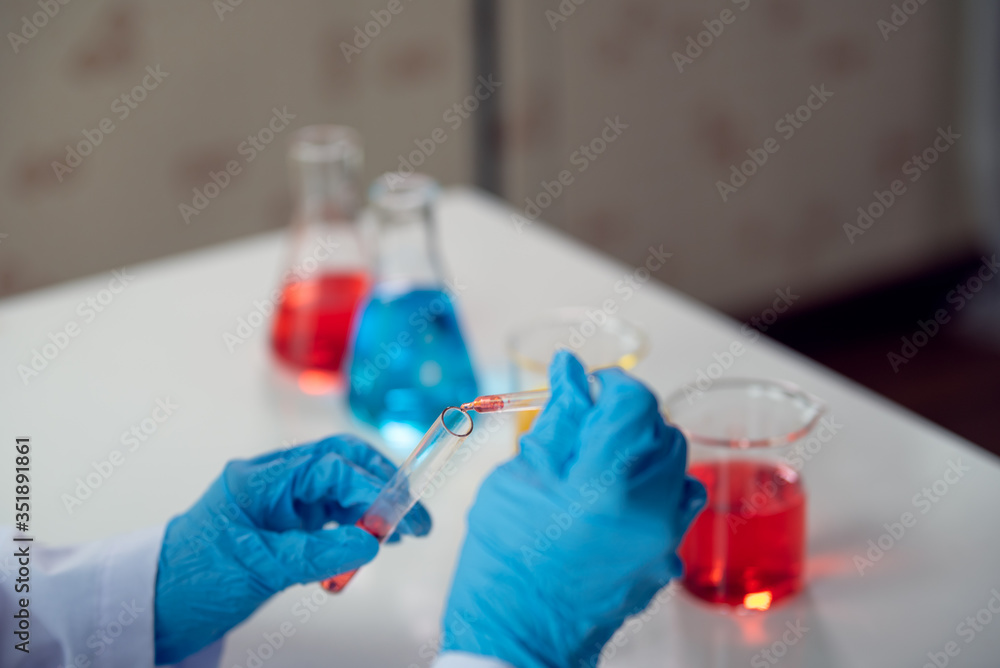 Scientist drop a sample chemical liquid to test tube in medical laboratory, Science and chemistry, Researcher test a sample concept Scientist drop a sample chemical liquid to test tube in medical laboratory, Science and chemistry, Researcher test a sample concept