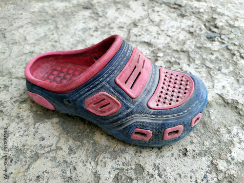 a dirty children footwear put on a ground