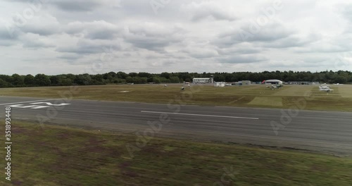 Helicopter cruising around at very low altitude at small airport, Blackbushe, England