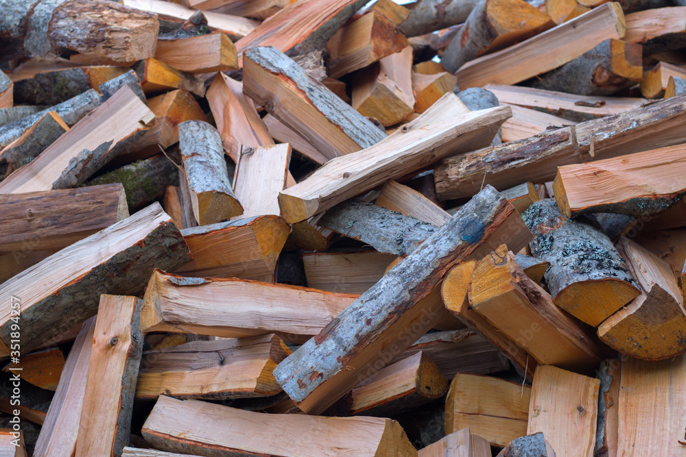 pile of firewood on a wooden background pile of firewood on a wooden background