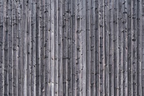 Textured wooden wall with vertical lines. Artistic and modern grey natural background.