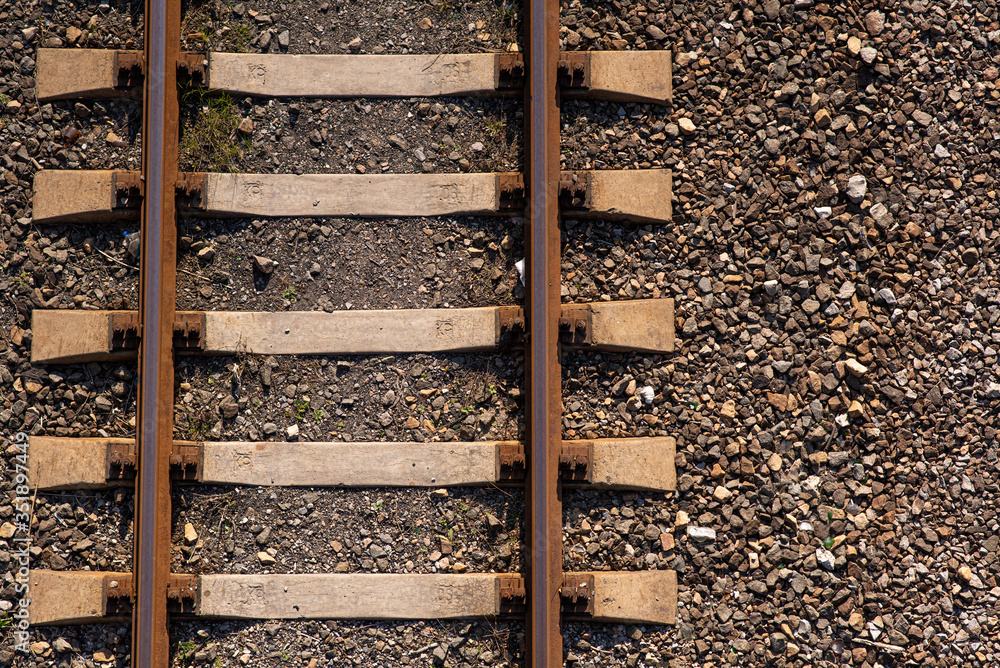 Old slightly rusty railroad tracks on which trains still ride. Old slightly rusty railroad tracks on which trains still ride.
