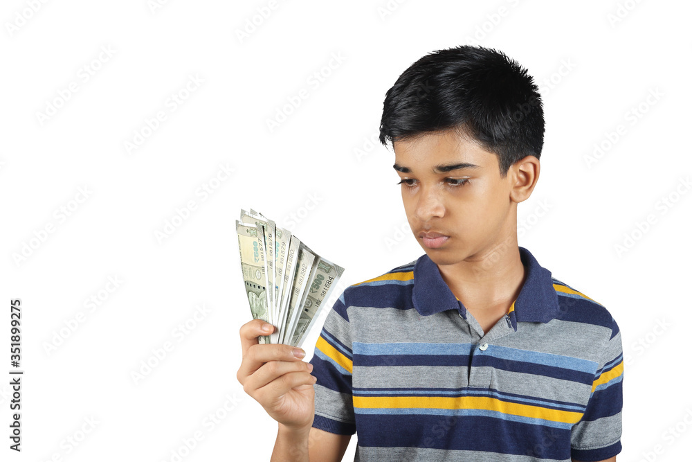 portrait of Young boy thinking about holding indian rupees his hand portrait of Young boy thinking about holding indian rupees his hand