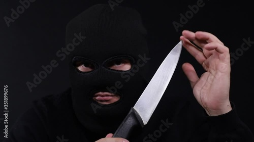 A criminal with a kitchen knife in his hands photo