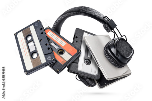 Portable player with headphones and tapes isolated on white