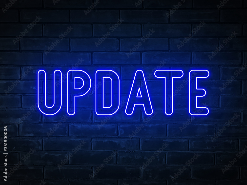 Update - blue neon light word on brick wall background