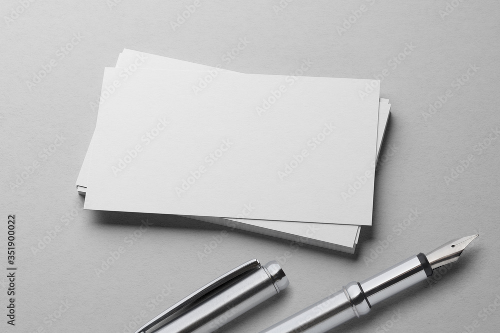 Mockup of business cards stack at white paper background Mockup of business cards stack at white paper background